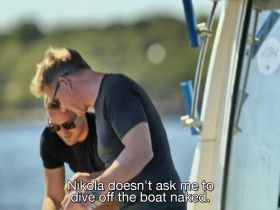 Two individuals engage in a lighthearted moment aboard a boat, showcasing the fun and camaraderie of a day on the water.