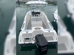 A detailed view of the interior helm and seating area of a sleek boat, showcasing modern design and functionality, perfect for day trips or fishing adventures.