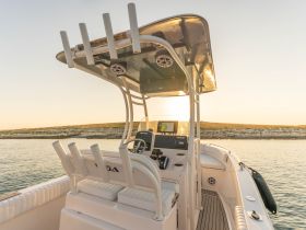 A well-equipped helm area of a boat featuring comfortable seating and modern navigation equipment, perfect for a day out on the water.