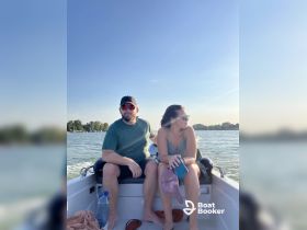 A couple enjoys a sunny day on a boat, capturing the essence of relaxation and adventure on the water.
