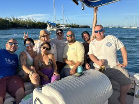 A lively group of friends enjoys a fun day on the water, celebrating together aboard a boat — perfect for memorable outings and adventures.