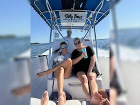 A joyful group enjoys their time aboard the 'Salty Paws' boat in Key West, perfect for snorkeling adventures and sunset cruises.