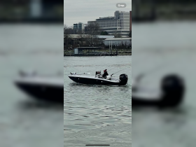A fisherman enjoys a day out on the water aboard a sleek speedboat, showcasing the thrill of fishing adventures.