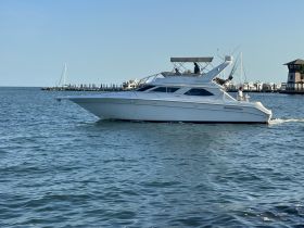 A sleek yacht cruising through calm waters, showcasing its elegant design and perfect for luxury outings on the sea.