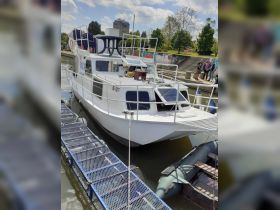 A well-structured boat docked at the marina, showcasing its design and surroundings. Ideal for exploring local waterways.