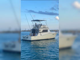 The 'Last Call' yacht navigates through tranquil waters, showcasing its sleek design and inviting atmosphere for fishing charters in Port Aransas, TX.