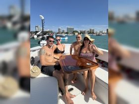 A lively group enjoys their time on a boat, showcasing a fun atmosphere perfect for celebrations and gatherings on the water.