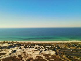 A scenic view of a beach and ocean, but the image lacks clarity and detail.