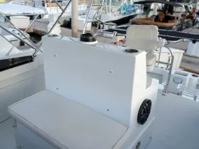 A clean and modern interior view of a boat's helm area, featuring comfortable seating and essential controls, perfect for a day on the water.