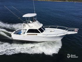 A sleek speedboat navigates through the water, showcasing its design and performance. Perfect for fishing trips or leisurely cruises.