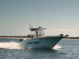 A speedboat named 'Odyssey' glides through the water, showcasing a thrilling day on the water — perfect for fishing or leisure outings.