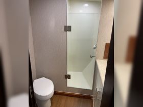 A clean and modern bathroom inside a boat, featuring a shower and toilet — perfect for comfortable cruising.