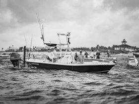 A group of fishermen aboard a boat enjoy a day on the water, showcasing the camaraderie and excitement of fishing adventures.