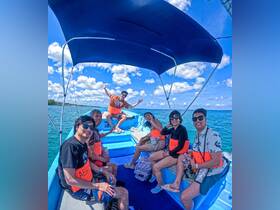A lively group enjoys a fun day on the water, showcasing smiles and camaraderie aboard a colorful boat — perfect for memorable outings and adventures.