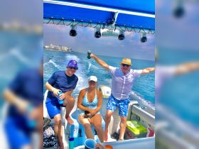 A lively group enjoys a fun day on the water, celebrating with drinks aboard a boat — perfect for summer outings and memorable adventures.