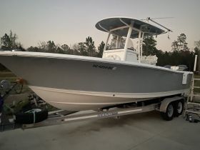 A sleek boat is docked and ready for adventure, showcasing its modern design and features — perfect for fishing or leisure outings.