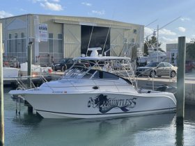 A sleek speedboat named 'Dauntless' docked at the marina, showcasing its impressive design and readiness for adventure.