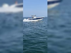 A speedboat glides through the water with passengers enjoying the ride, capturing the thrill of a day on the open sea.