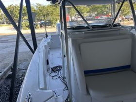 Interior view of a boat showcasing the seating and helm area, ideal for comfortable cruising and fishing trips.