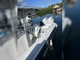 Interior view of a well-equipped boat featuring comfortable seating and a helm, ideal for fishing or leisure outings on the water.
