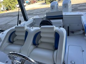 Interior view of a boat's seating and helm area, showcasing comfortable seating and a clean layout, ideal for fishing or cruising.