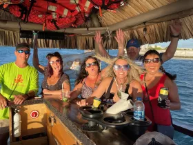 A lively group of friends celebrates aboard a boat, enjoying drinks and good times on the water — perfect for unforgettable party experiences.
