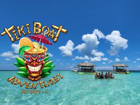 A lively group enjoys a fun day at the tiki boat in Key West, surrounded by clear waters and vibrant skies — perfect for a tropical adventure.