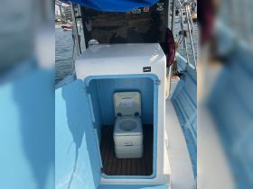 A clean and functional boat bathroom featuring a portable toilet, ideal for comfort during day trips on the water.