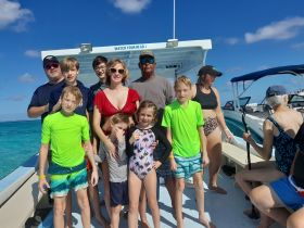 A joyful family poses together on a boat, enjoying their time on the water — perfect for memorable group outings and celebrations.