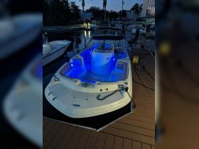 A beautifully lit boat docked at night, showcasing its sleek design and inviting atmosphere — perfect for evening outings on the water.