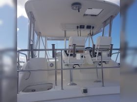Interior view of a boat's helm and seating area, showcasing the modern design and functionality ideal for navigation and comfort.