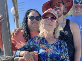 A cheerful group poses for a photo, showcasing their fun day out on the water — perfect for capturing memorable moments during boating adventures.