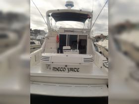 A clear view of the back of the 'Meco Yate' yacht docked at the marina, showcasing its sleek design and features.
