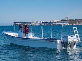 A center console boat is seen navigating the waters near La Paz, B.C.S., showcasing its sleek design and functionality — perfect for fishing or day trips.