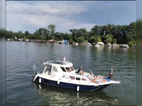 A lively group enjoys a day on the water aboard a boat, showcasing relaxation and fun in a picturesque setting.