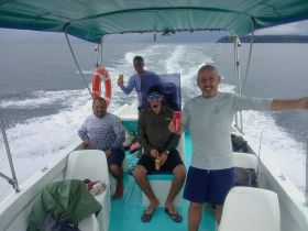 A group of friends enjoys a fun day on the water, celebrating with drinks aboard a boat — perfect for fishing trips or leisurely outings.