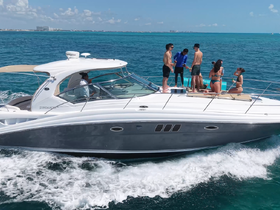 A lively group enjoys a day on the water aboard a yacht, celebrating with cocktails and soaking up the sun — the perfect backdrop for unforgettable summer memories.