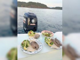 Deliciously prepared meals featuring grilled meats and fresh salads, perfect for enjoying on a boat trip. Ideal for catering or onboard dining experiences.