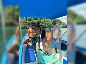 A lively group prepares for snorkeling on a boat, showcasing the excitement of aquatic adventures in a beautiful setting.