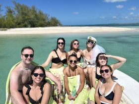 A lively group of friends celebrates a bachelorette party on a pontoon boat, enjoying the sun and turquoise waters — the perfect backdrop for unforgettable memories.