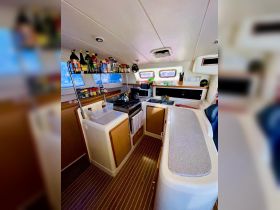 A well-equipped boat kitchen featuring ample storage and cooking facilities, perfect for preparing meals while enjoying life on the water.