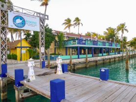 A scenic view of the Bimini Big Game Club Resort & Marina, showcasing the vibrant architecture and serene waters, perfect for fishing enthusiasts and vacationers.