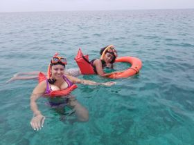 Two friends enjoy snorkeling in crystal-clear waters, showcasing the fun and adventure of underwater exploration.