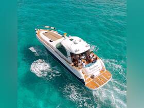 A lively group enjoys a day on the water aboard the 'Island Gypsy,' cruising through stunning turquoise waters — perfect for celebrations and group outings.