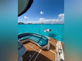 A vibrant view of a boat's lounge area featuring comfortable seating, with a whimsical floating unicorn in the turquoise waters — perfect for relaxation and fun on the water.