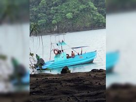 A vibrant boat with people enjoying the scenic coastline, perfect for a day of adventure on the water.