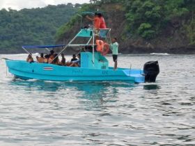 A lively group enjoys a boat ride, showcasing the fun and camaraderie of on-water adventures in a vibrant blue vessel.