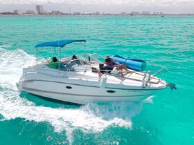 A lively group enjoys a day out on a boat, cruising through stunning turquoise waters — perfect for adventure and relaxation on the water.