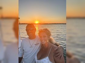 A couple enjoys a romantic sunset on the water, capturing a perfect moment aboard their boat — ideal for special occasions or sunset cruises.
