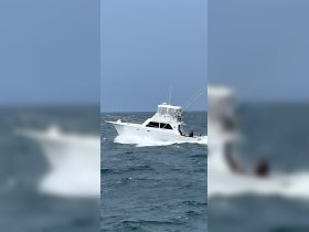 A sleek speedboat navigates through the waves, showcasing its impressive design and fishing gear — perfect for adventurous outings on the water.